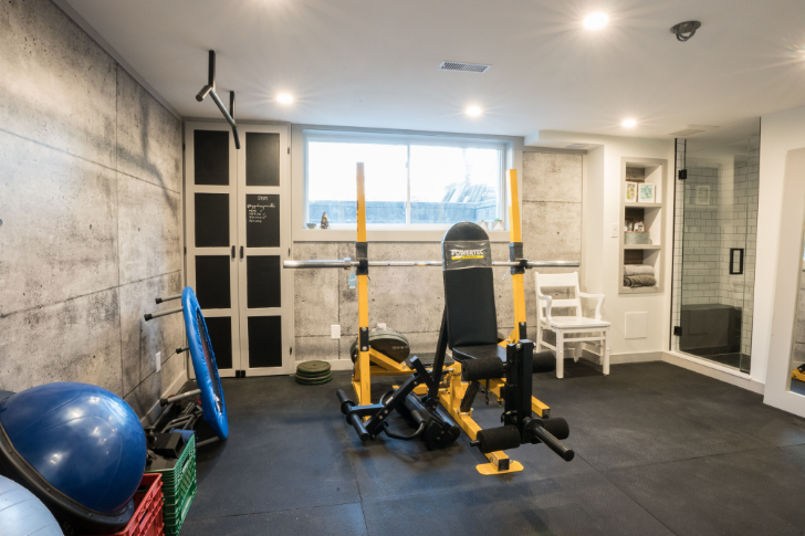 This basement gym by RenoMark member Morgan Quality Homes in Ottawa, ON has plenty of space to move, functional flooring, and a shower.  