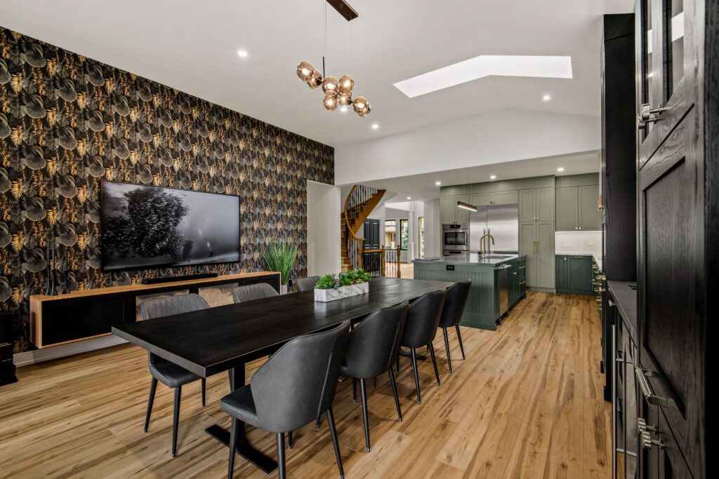 open concept green kitchen with dark wallpaper accent wall