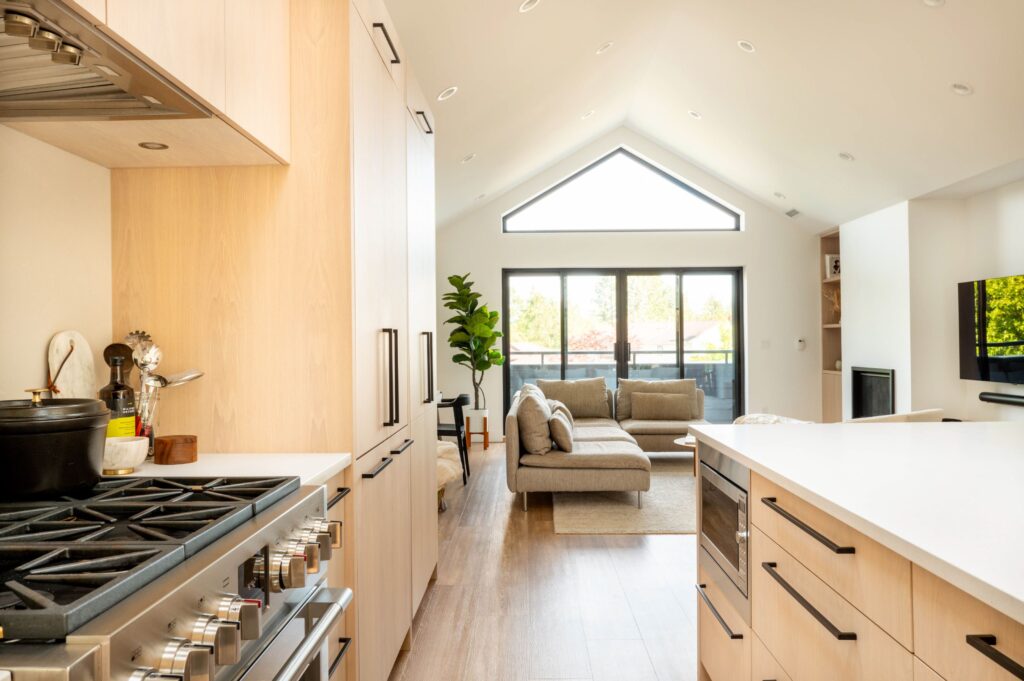 Light and airy kitchen and open concept living room. Light wood, large windows