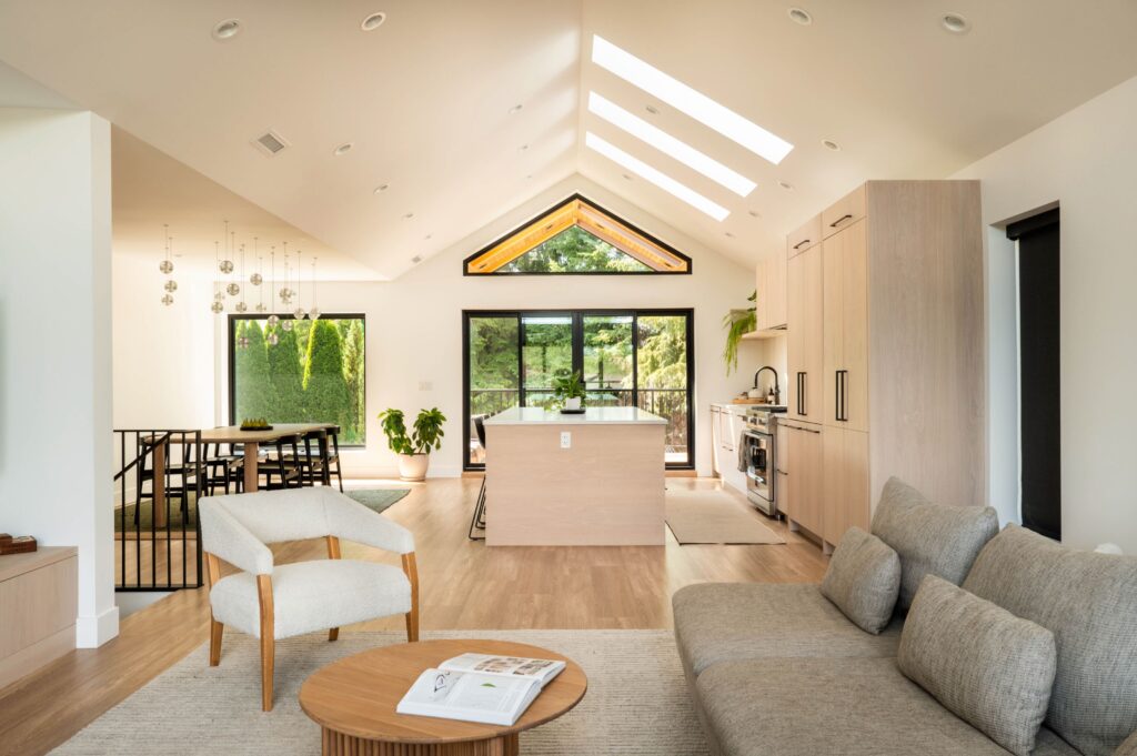 Light and airy kitchen and open concept living room. Light wood, large windows