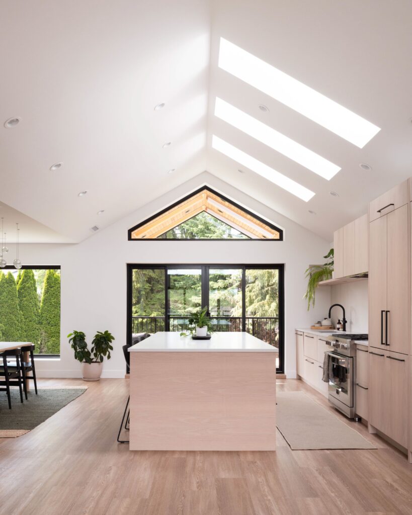 Light and airy kitchen and open concept living room. Light wood, large windows