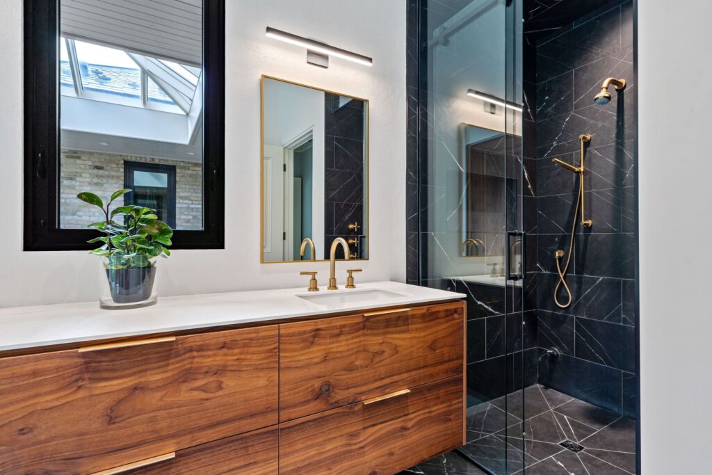 Elegant Bathroom Design with Black Tiles and Gold Fixtures