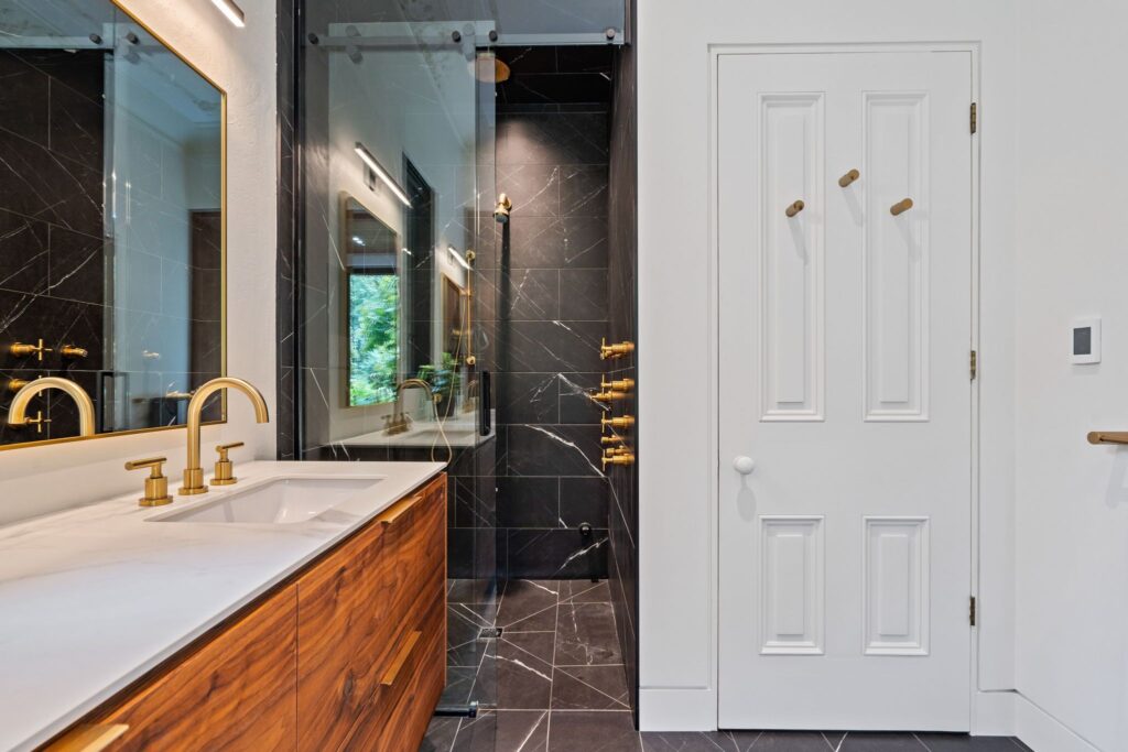 Sophisticated Bathroom with Gold Accents and Walnut Details