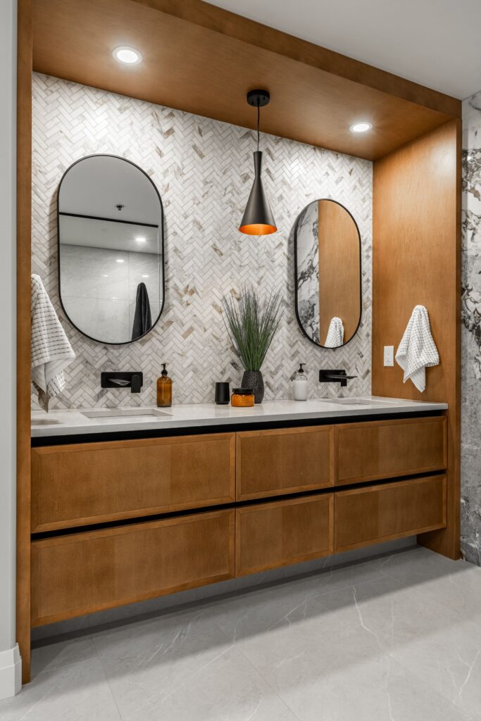 Custom floating vanity with black hardware and feature lighting