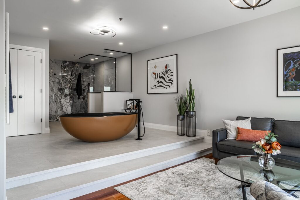 Raised bathroom creating separation and dimension in the suite