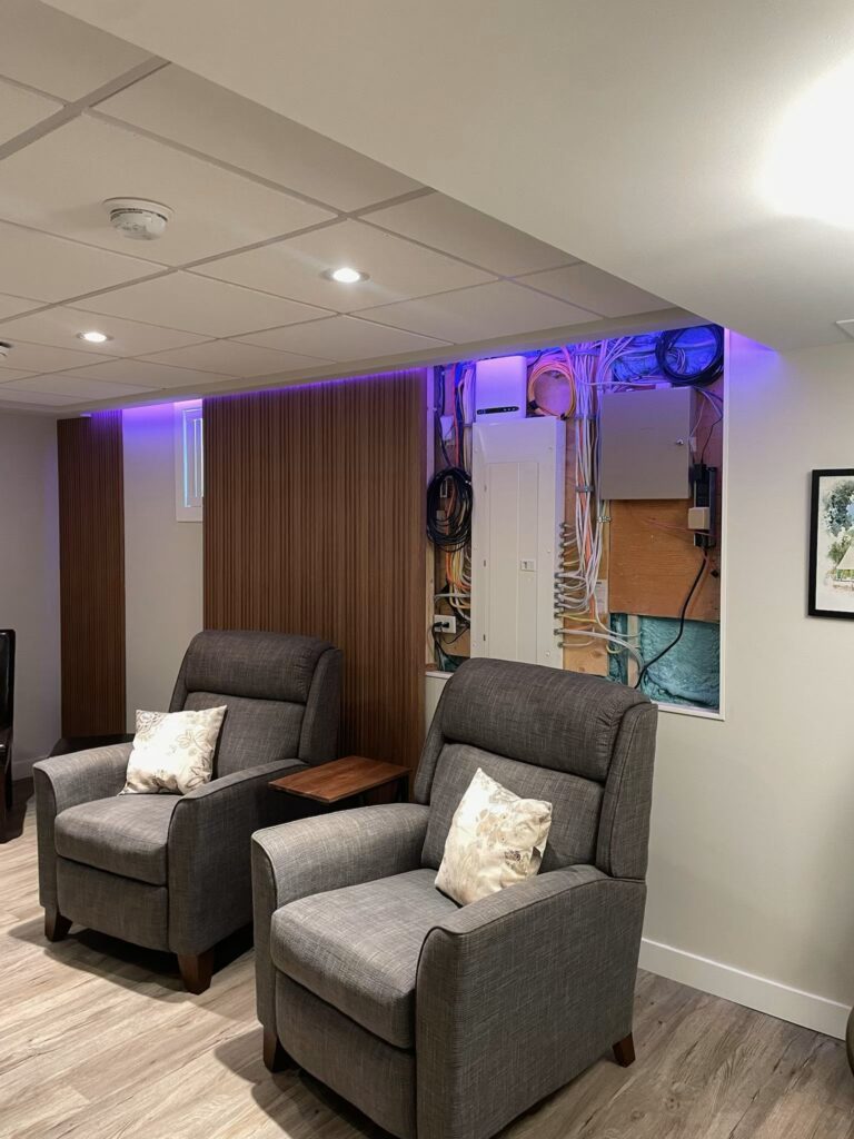 Feature wall designed to hide and provide access to the electrical panel.