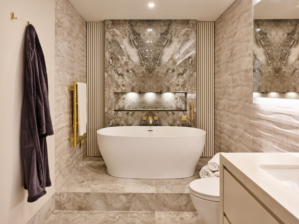 Modern Ensuite Retreat: A contemporary bathroom with a six-foot tub featuring a heated back-rest and integrated LED lighting.