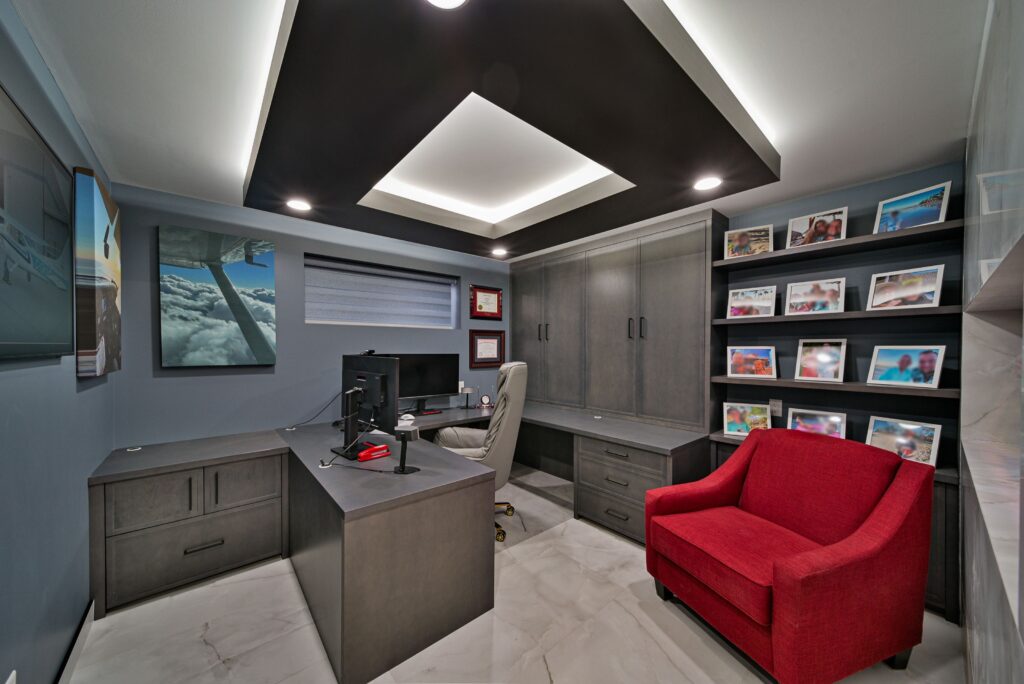 Modern basement office with smart lighting and dual monitors.