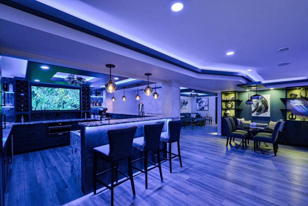 Multi-zone entertainment space with large screen and surround seating.