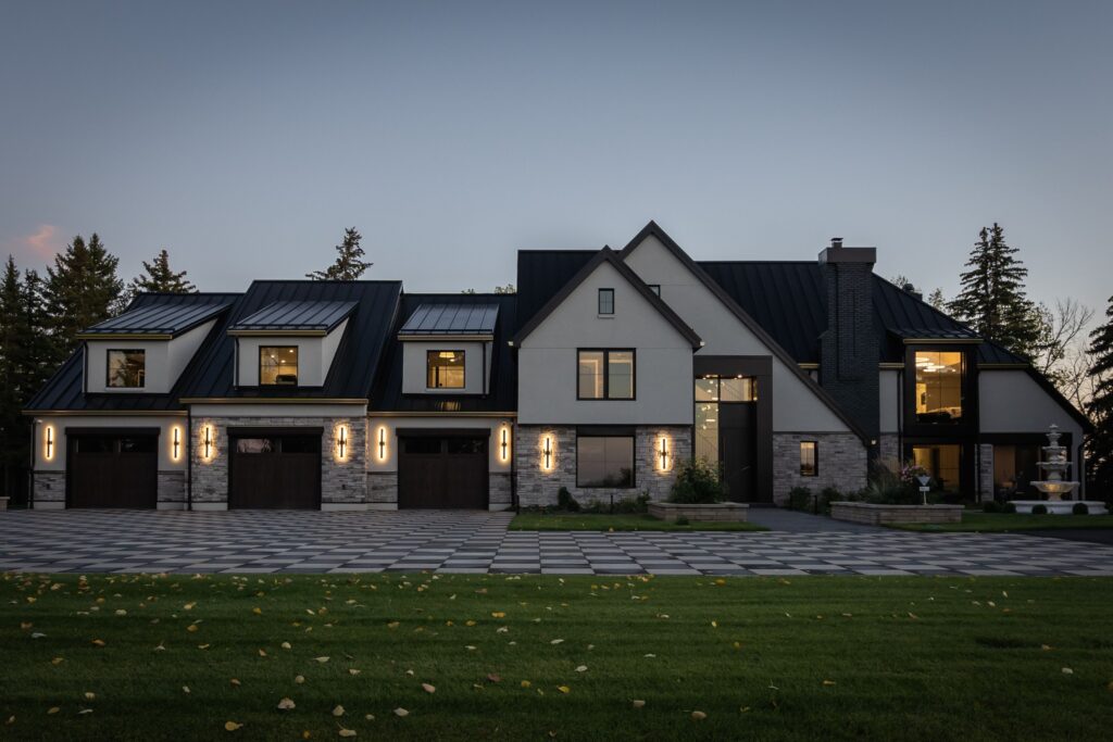 Front view of a newly transformed home featuring a welcoming entrance, new façade, and a spacious triple garage