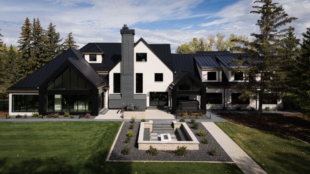 Modern Tudor-style home exterior with rich dark tones, showcasing a blend of materials and brass accents, highlighted by energy-efficient windows.