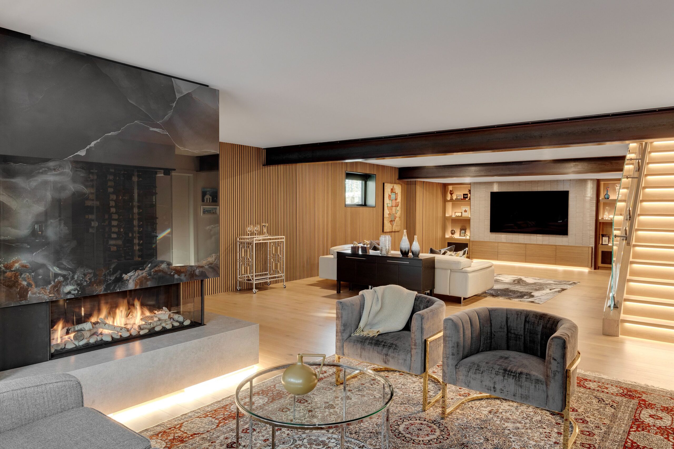 Fluted wood paneling adds warmth and texture to the basement living space.