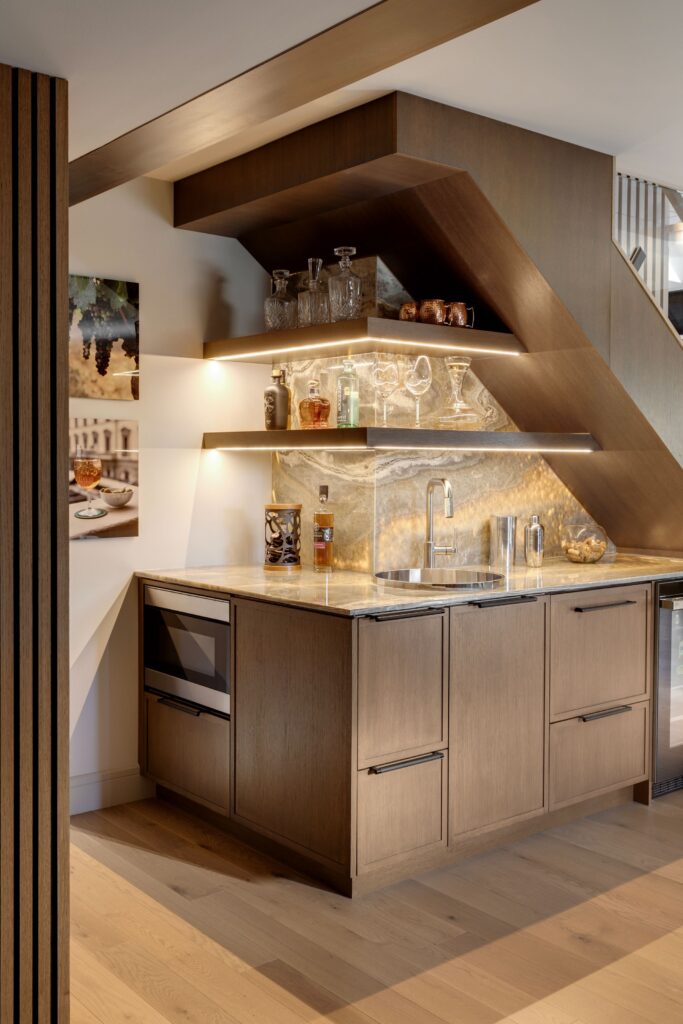 Backlit onyx bar with integrated LED lighting in a luxurious basement.