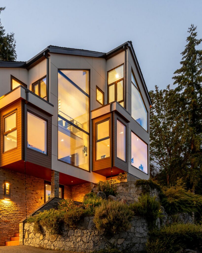 Clean exterior facade with wood, stone, and glass railings