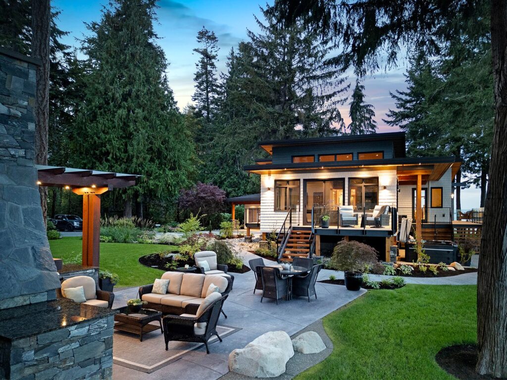 Butterfly roofline and natural finishes connecting indoor and outdoor spaces.