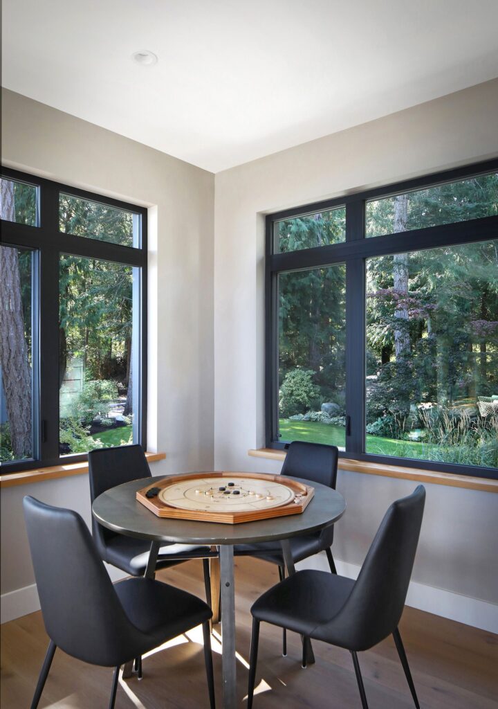 Modern games room with large windows showcasing coastal views