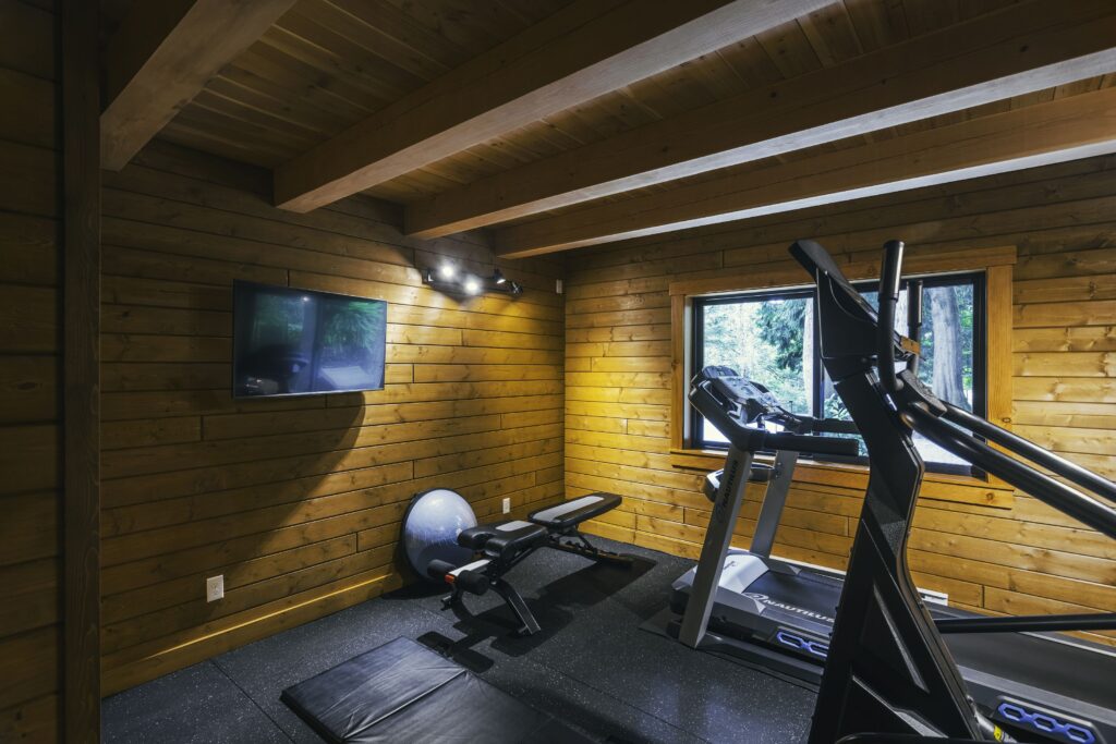 Indoor gym space in rustic log home