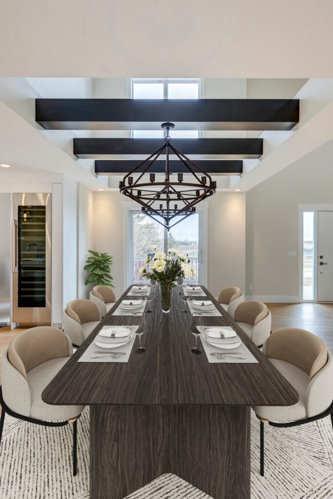 Dining area in modern home renovation with stained beams and streamlined open layout.