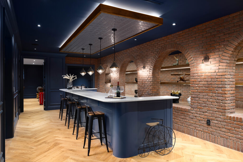 A bar with stools and lights.