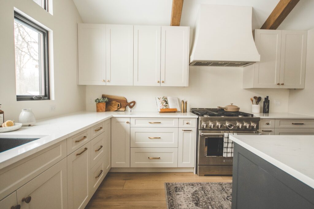A kitchen with white cabinets and a stove.