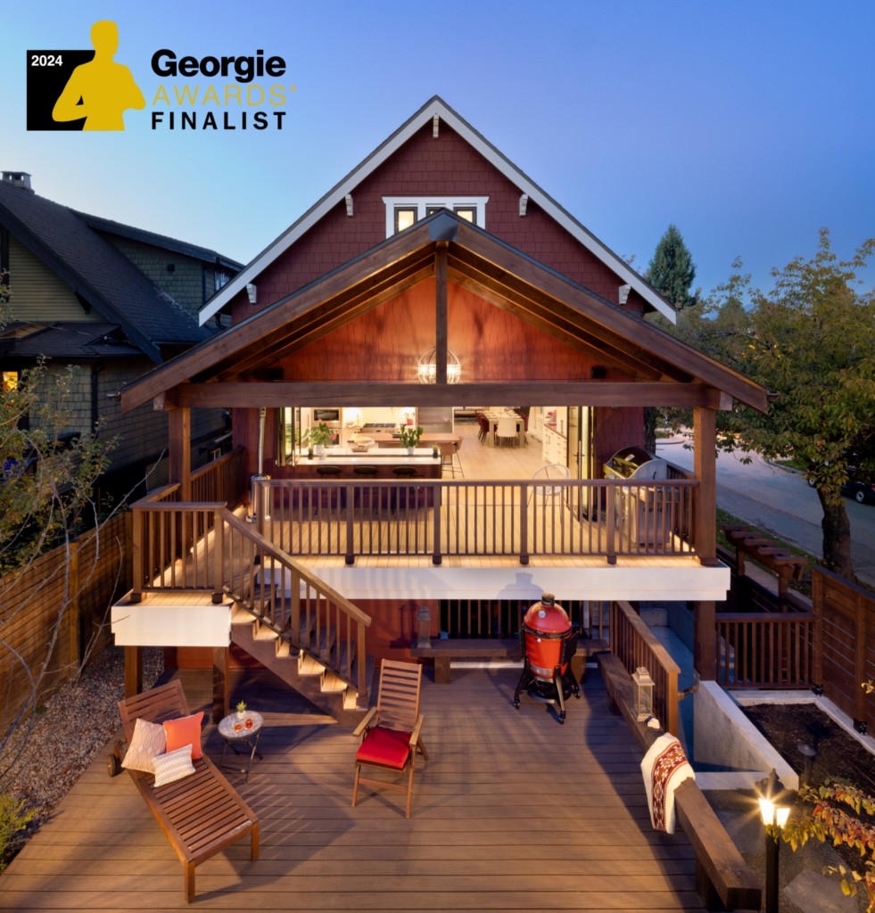 A two-story house with a wooden deck and outdoor seating area at dusk. The deck has lounge chairs, a BBQ grill, and stairs leading to a covered patio. A 2024 Georgie Awards Finalist badge is in the top left corner.