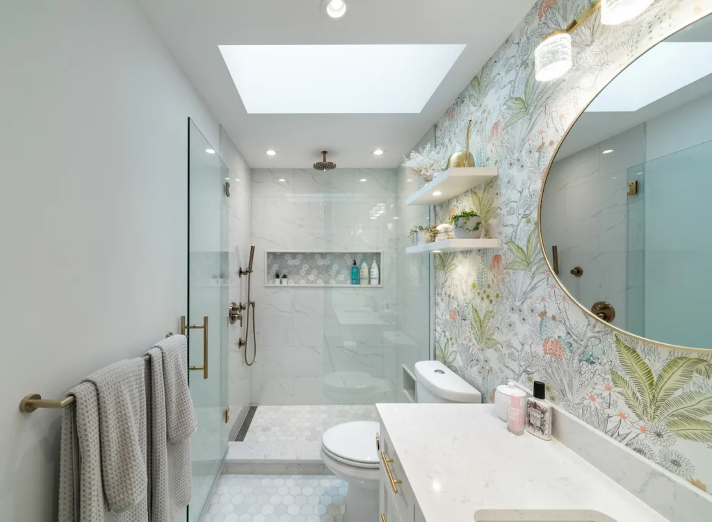 A bathroom with a mirror and a shower.