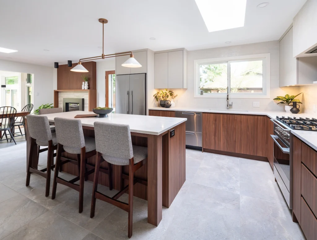 A kitchen with a large island and a refrigerator.