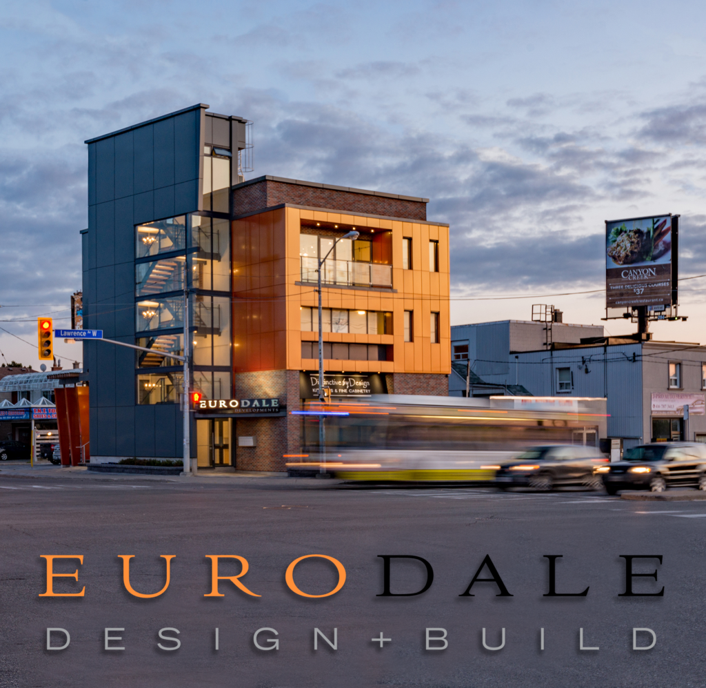 A modern, three-story building with a glass and orange facade stands on a busy street corner at dusk. Blurred vehicles pass by, and EURODALE DESIGN+BUILD is displayed at the bottom of the image.