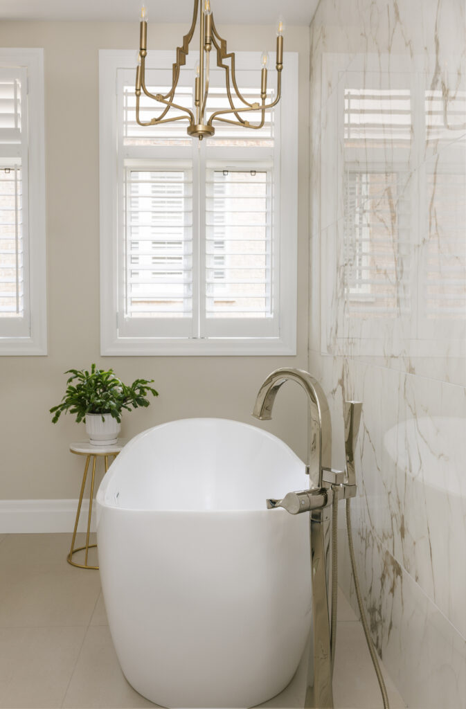 A bathroom with a tub and a plant.