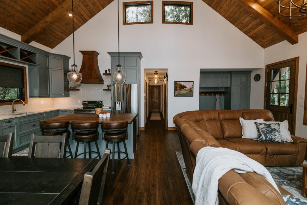 A living room with a couch and kitchen.