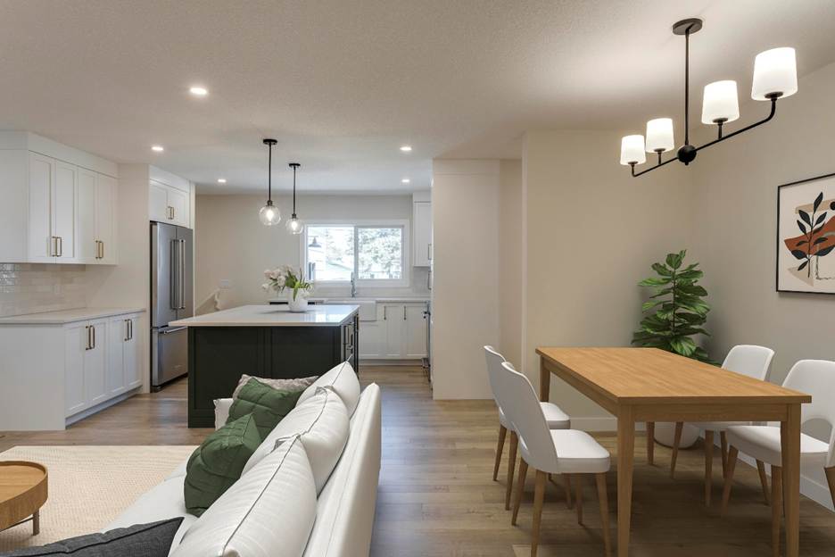 Modern open-concept kitchen and dining area with white cabinets, stainless steel appliances, a central island, a wooden dining table with white chairs, a sofa, a potted plant, and wall art. Natural light fills the space.